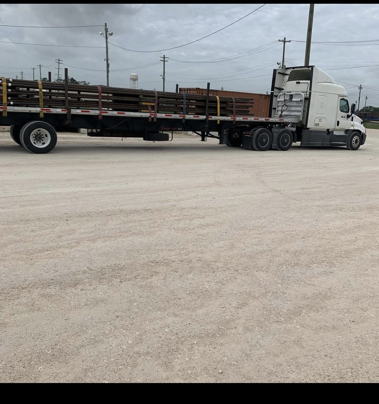 NLG flatbed trailer loaded with steel pipe